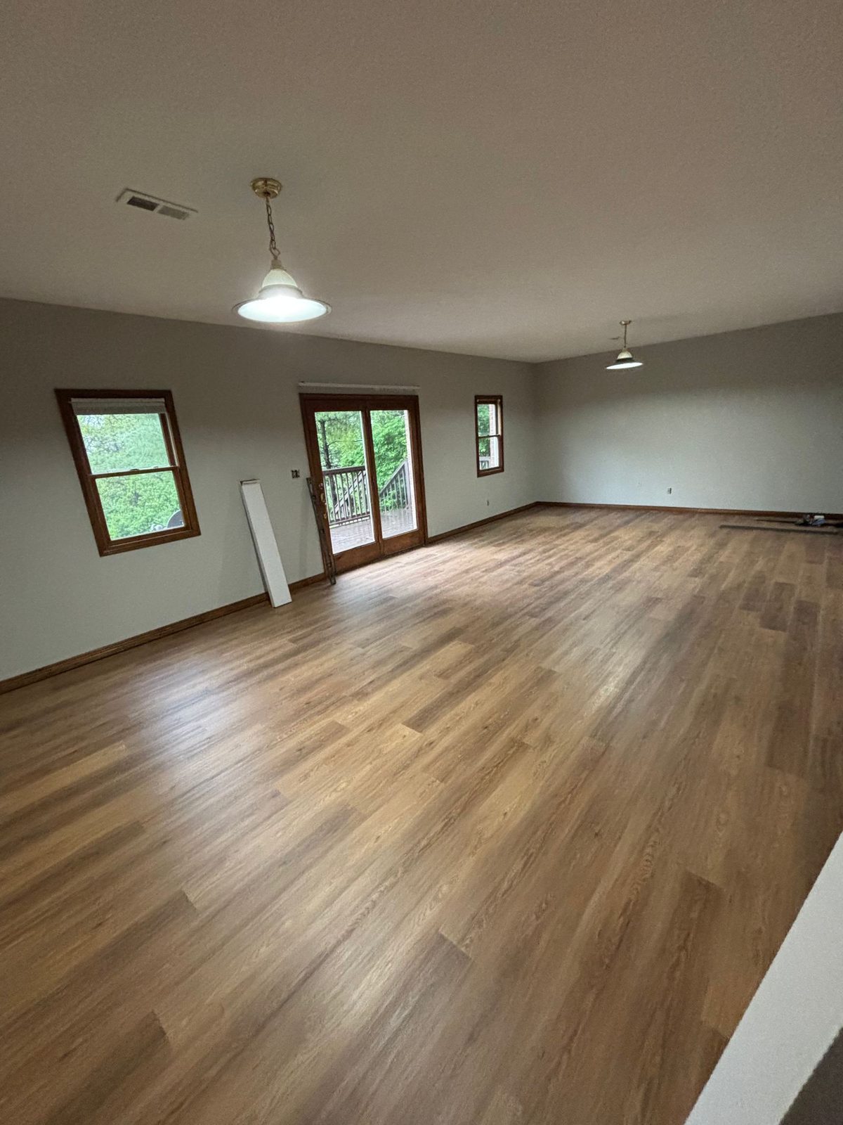 Open plan room with warm blonde LVP